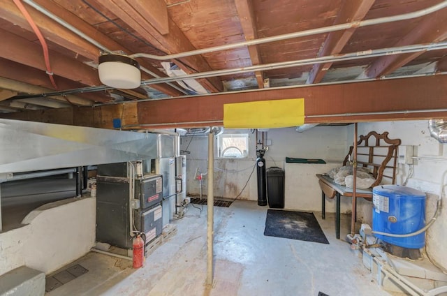 basement with gas water heater and heating unit