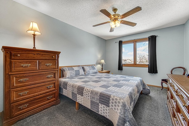 bedroom featuring a textured ceiling, dark colored carpet, and ceiling fan