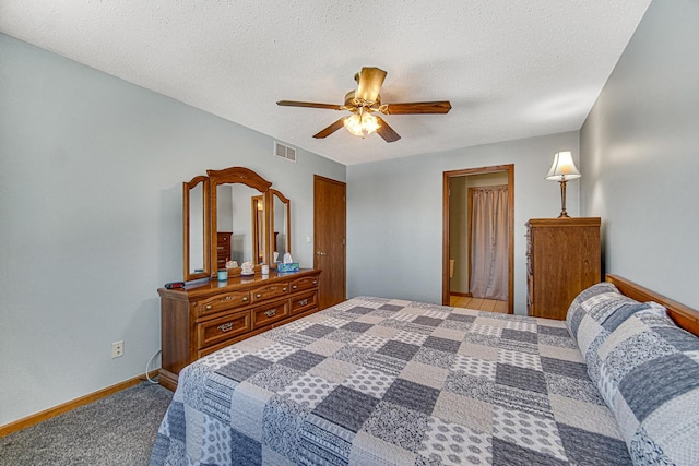 carpeted bedroom featuring a textured ceiling and ceiling fan