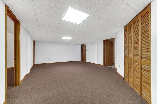 basement with carpet and a drop ceiling