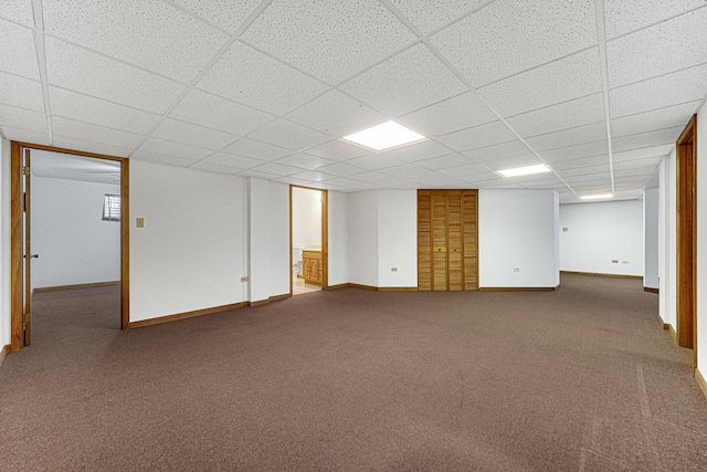 basement with carpet floors and a drop ceiling