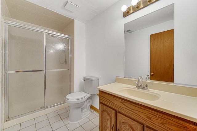 bathroom with tile patterned floors, toilet, vanity, and an enclosed shower