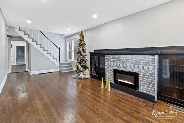 unfurnished living room with a fireplace and dark hardwood / wood-style flooring