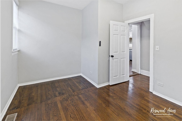 empty room featuring dark hardwood / wood-style flooring