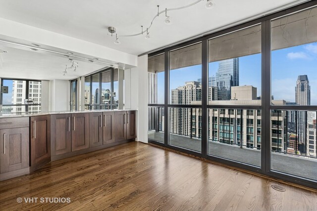 10 E Ontario St Unit 4308, Chicago, IL 60611 - empty room featuring a view of skyline, expansive windows, and wood finished floors