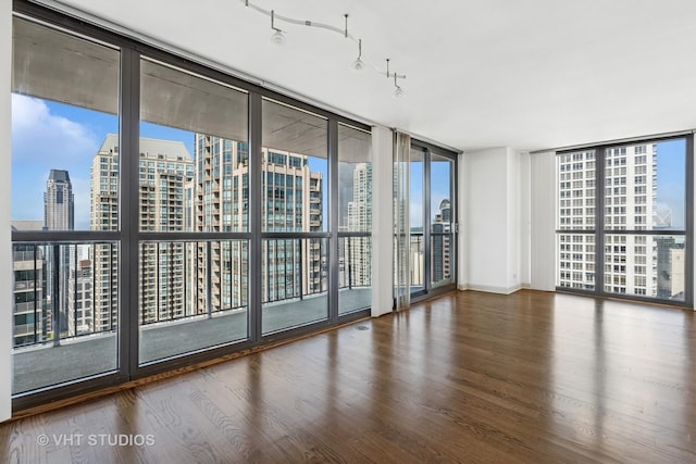 10 E Ontario St Unit 4308, Chicago, IL 60611 - spare room featuring expansive windows, a view of city, and wood finished floors