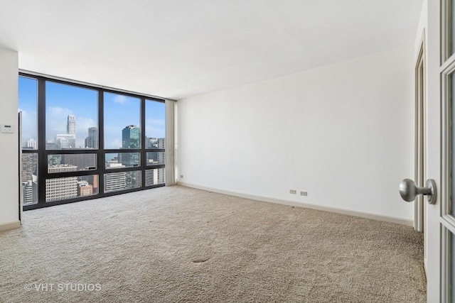 10 E Ontario St Unit 4308, Chicago, IL 60611 - carpeted spare room with a view of skyline, expansive windows, and baseboards