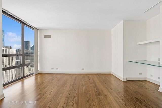 10 E Ontario St Unit 4308, Chicago, IL 60611 - spare room featuring wood finished floors, floor to ceiling windows, baseboards, and a view of city