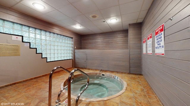 10 E Ontario St Unit 4308, Chicago, IL 60611 - interior space featuring wooden walls, a jacuzzi, baseboards, a paneled ceiling, and recessed lighting