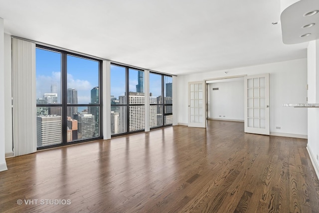 10 E Ontario St Unit 4308, Chicago, IL 60611 - unfurnished living room with wood finished floors, baseboards, and a view of skyline