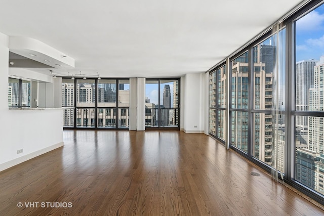 10 E Ontario St Unit 4308, Chicago, IL 60611 - unfurnished room featuring a wall of windows, wood finished floors, baseboards, and a view of city