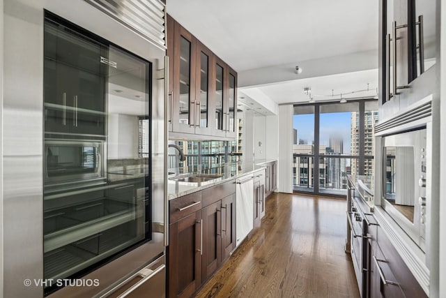 10 E Ontario St Unit 4308, Chicago, IL 60611 - kitchen with a sink, dark wood-type flooring, a city view, dishwasher, and glass insert cabinets
