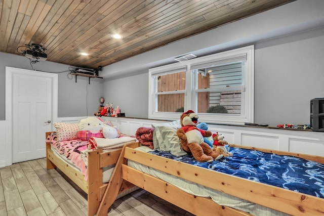 bedroom featuring wood ceiling and light hardwood / wood-style flooring