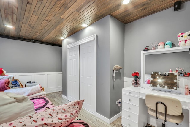 bedroom with a closet, wooden ceiling, and light hardwood / wood-style floors