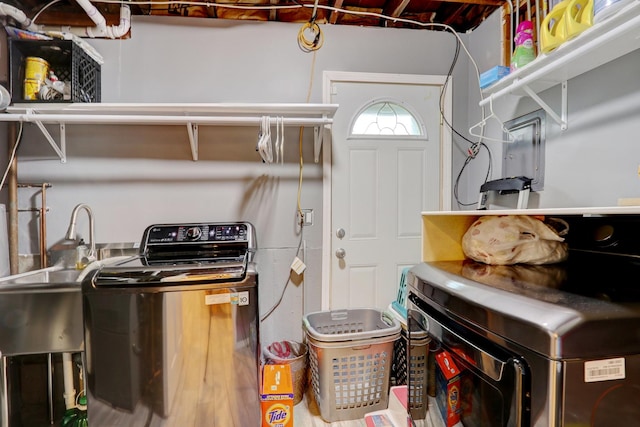 clothes washing area with sink