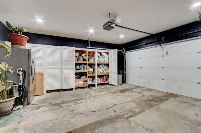 garage featuring a garage door opener and stainless steel fridge