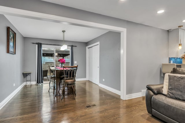 dining room with dark hardwood / wood-style flooring