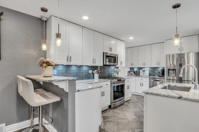 kitchen with white cabinetry, sink, and stainless steel appliances