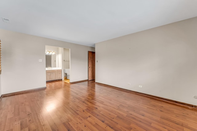 empty room with sink and light hardwood / wood-style floors