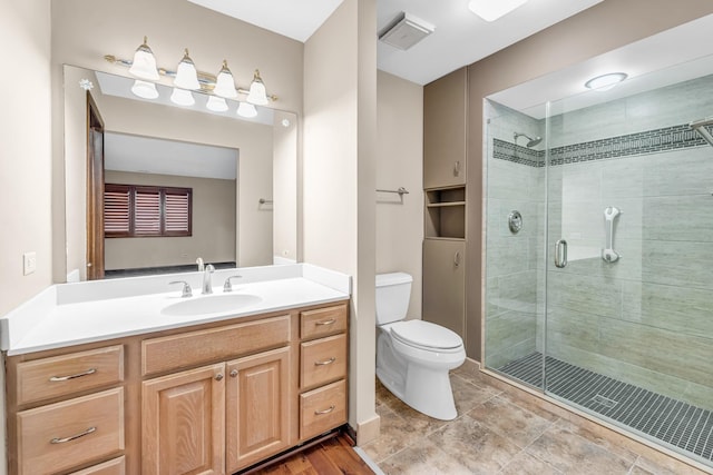 bathroom featuring walk in shower, vanity, and toilet