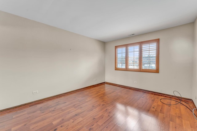 unfurnished room featuring hardwood / wood-style flooring