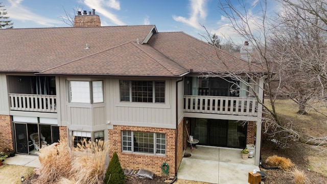 rear view of house with a patio area and a balcony