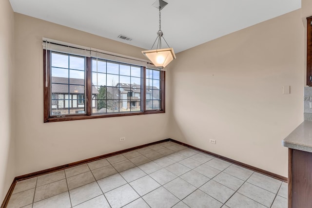 unfurnished dining area featuring light tile patterned floors