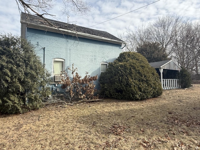 view of side of home with a lawn