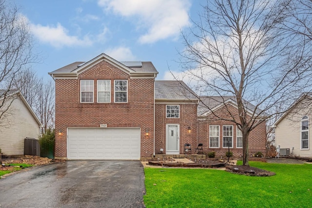 view of front of property with a garage, central air condition unit, and a front lawn