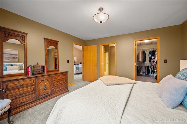 bedroom with light carpet, a walk in closet, and a closet