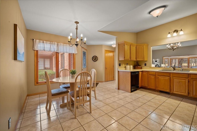 kitchen featuring decorative light fixtures, dishwasher, sink, a chandelier, and light tile patterned floors