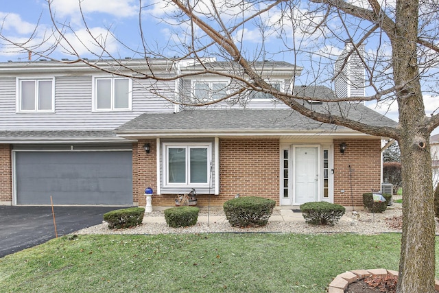 view of front of property featuring a garage and a front lawn