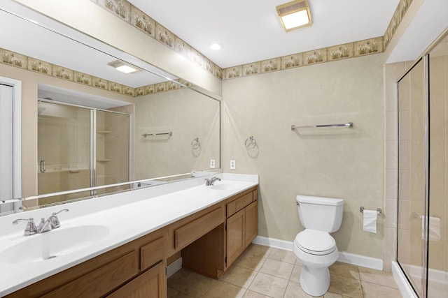 bathroom with tile patterned flooring, vanity, an enclosed shower, and toilet