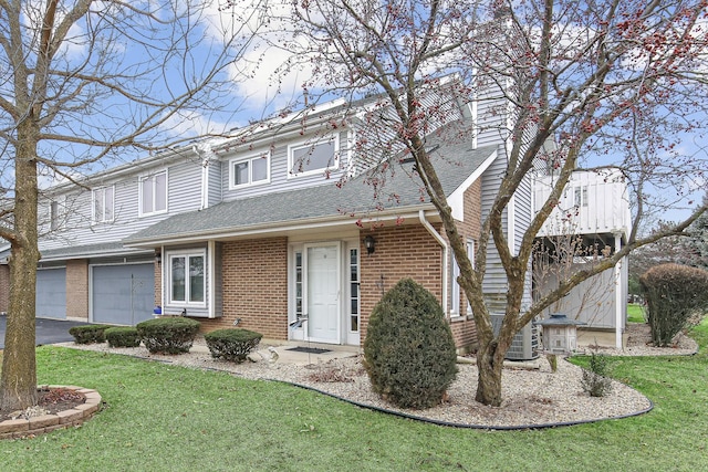 view of front of house featuring a garage and a front lawn