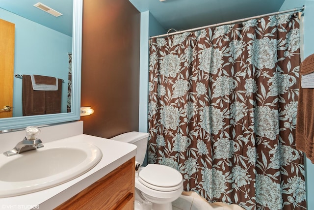 bathroom with vanity, toilet, and tile patterned flooring