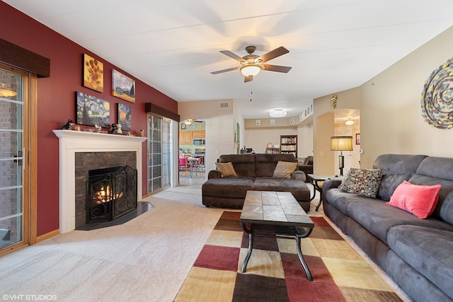 carpeted living room with ceiling fan