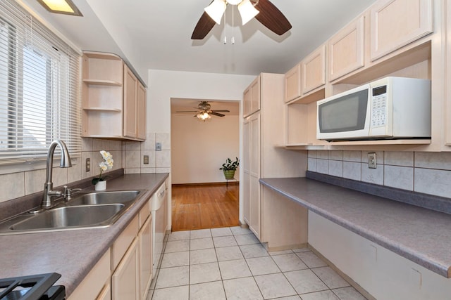 kitchen featuring sink, white appliances, tasteful backsplash, ceiling fan, and light tile patterned flooring