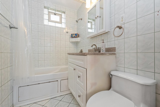 full bathroom with shower / tub combo with curtain, tile patterned flooring, tile walls, and toilet