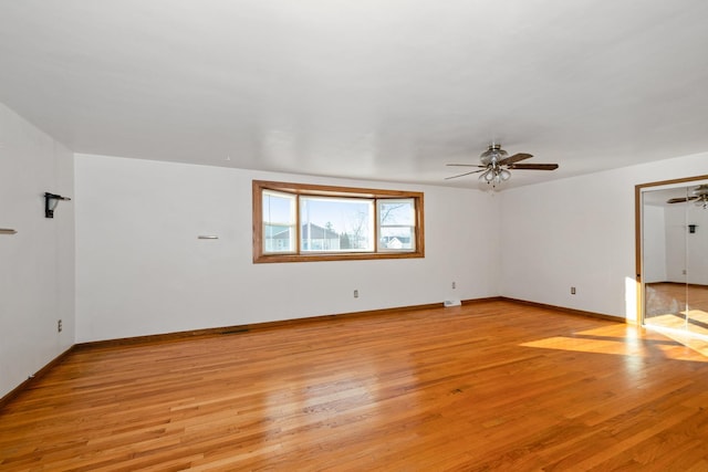 empty room with light wood-type flooring and ceiling fan