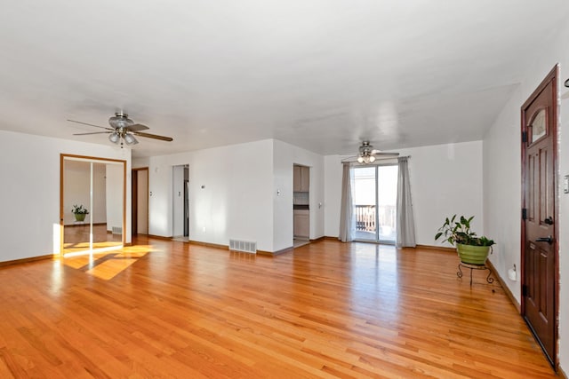 unfurnished living room featuring ceiling fan and light hardwood / wood-style floors