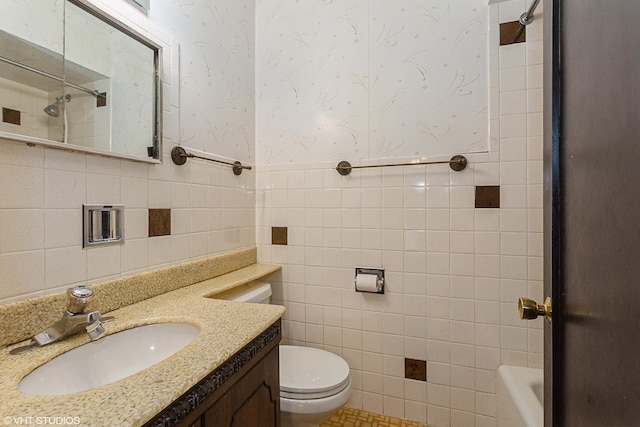 full bathroom featuring vanity, toilet, shower / bath combination, and tile walls