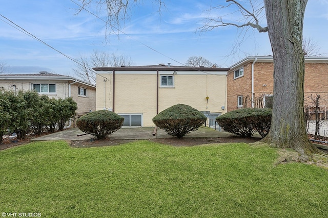 rear view of property featuring a lawn