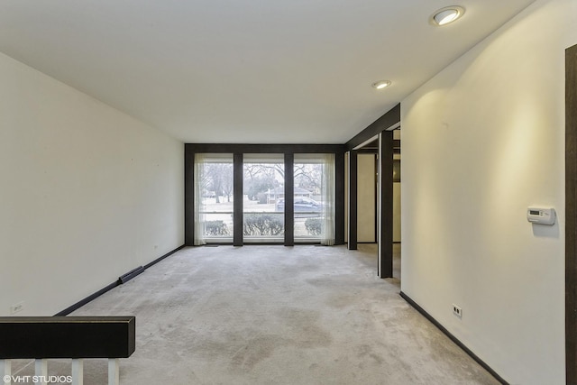 unfurnished room with light colored carpet