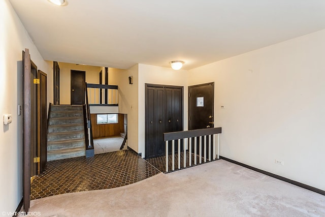 foyer entrance with carpet floors