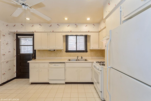 kitchen featuring sink, white appliances, light tile patterned floors, ceiling fan, and white cabinets