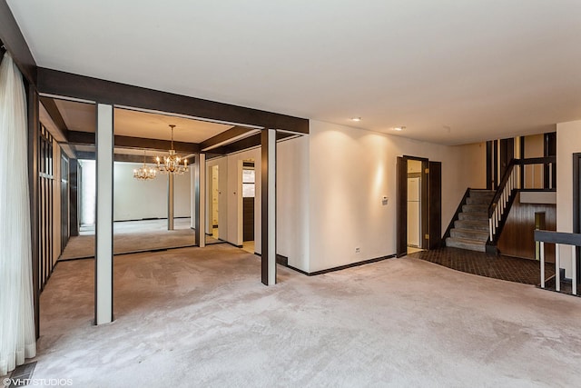 basement featuring carpet floors and a notable chandelier