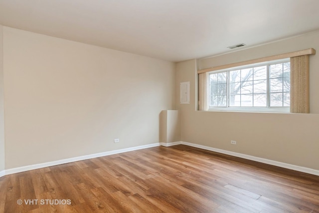 spare room with hardwood / wood-style floors