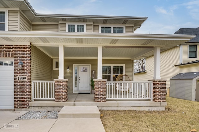 entrance to property featuring a porch and a garage