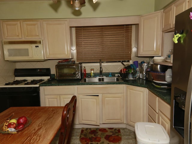 kitchen featuring stainless steel refrigerator with ice dispenser, sink, gas range oven, and decorative backsplash