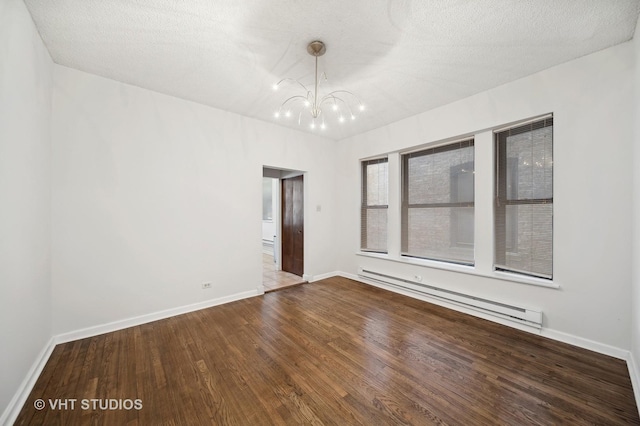 unfurnished room featuring baseboards, wood finished floors, an inviting chandelier, baseboard heating, and a textured ceiling